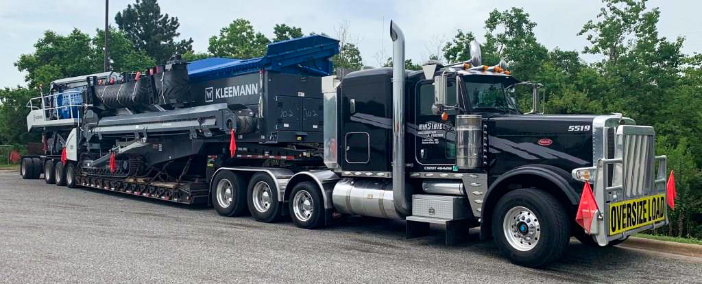Midstate Companies truck hauling a Kleemann crushing plant.